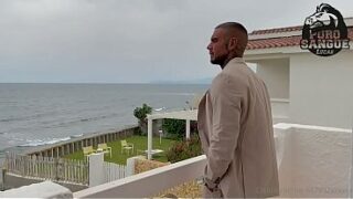A muscular businessman jerks off in his beachfront villa