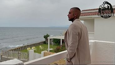 A muscular businessman jerks off in his beachfront villa
